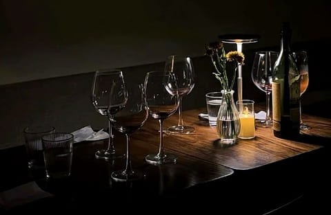 Glasses and a candle on the wine bar table